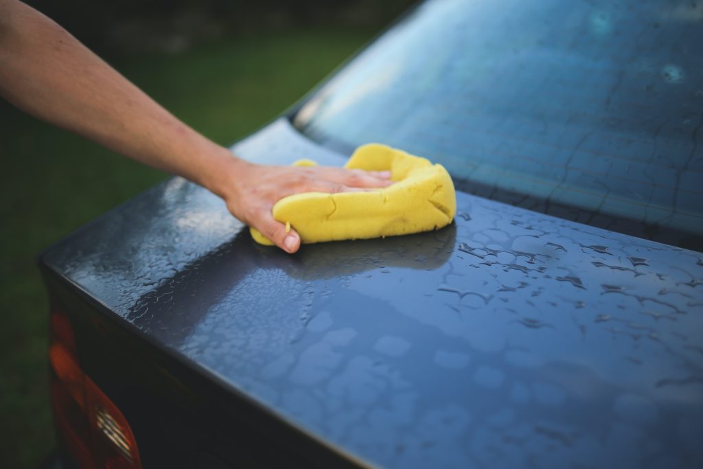 Black car being washed at a car wash fundraiser