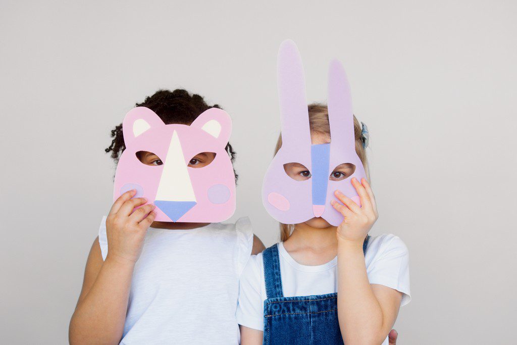 two kids playing around with their arts and crafts at a fundraiser