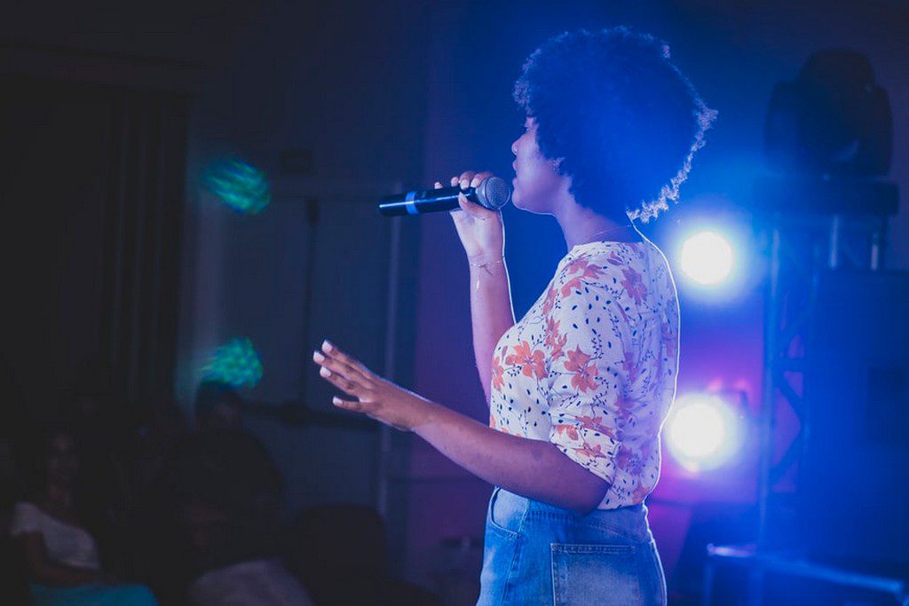 woman singing on stage