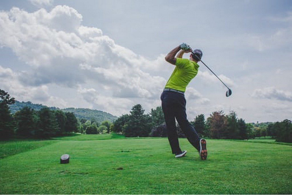 golf player teeing off