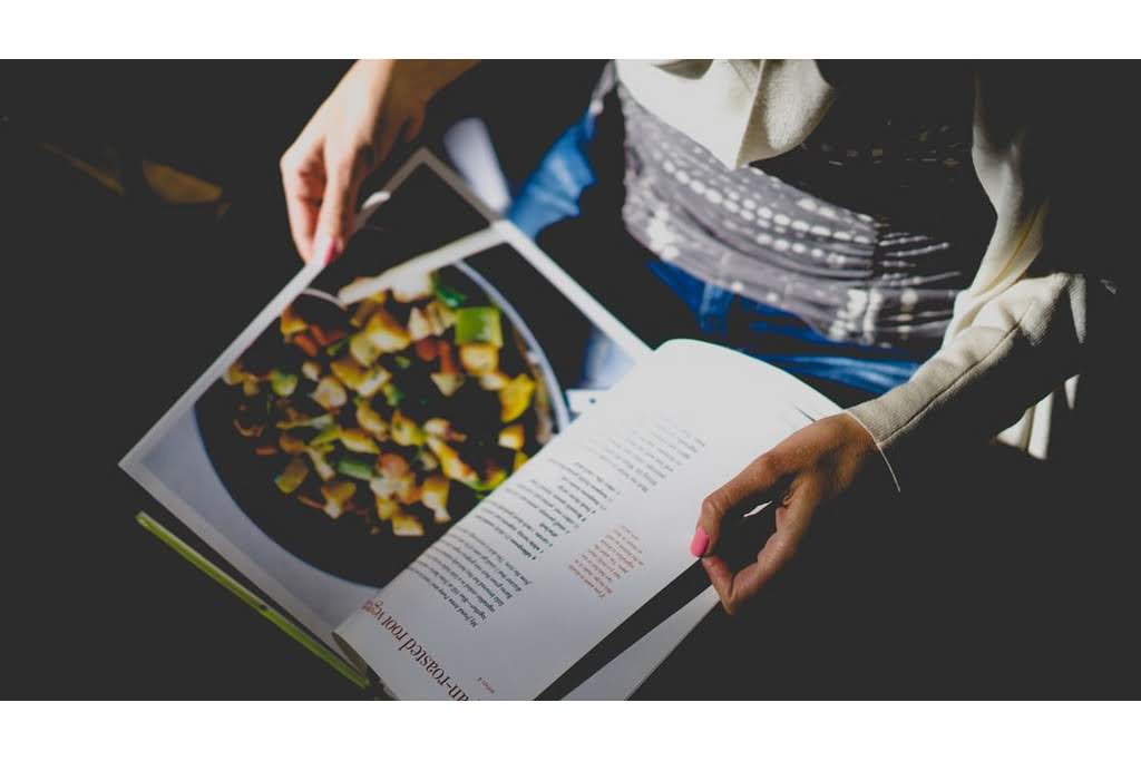 A person reading a cookbook