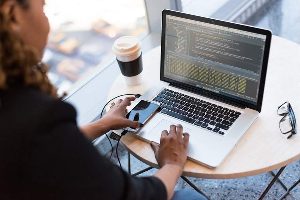 woman on phone and computer