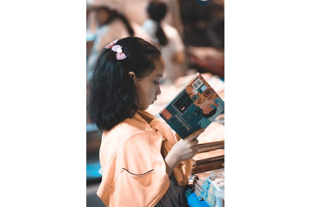 girl reading at table