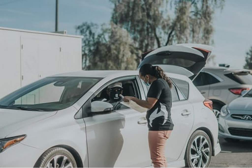 man attending to vehicle