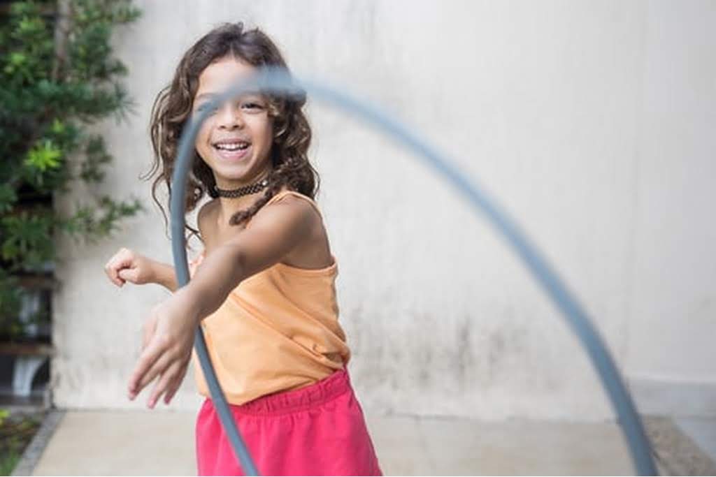 girl playing with hoola hoop