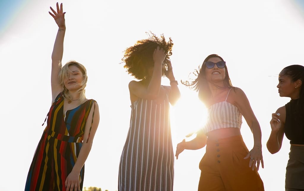 Young women outside smiling