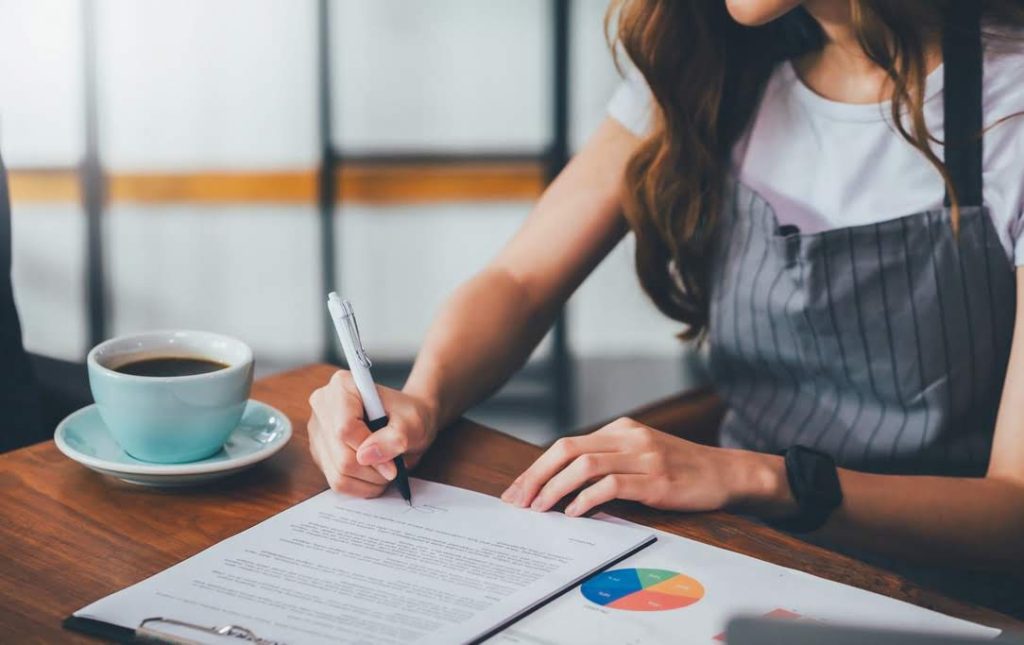 woman signing documents