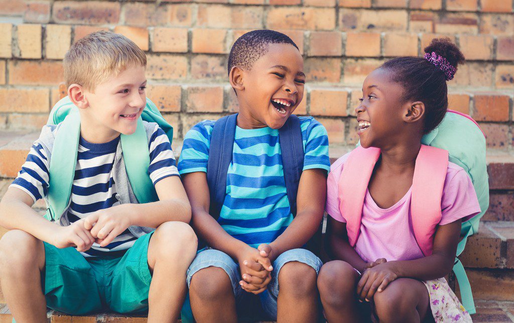 three kids laughing at puns