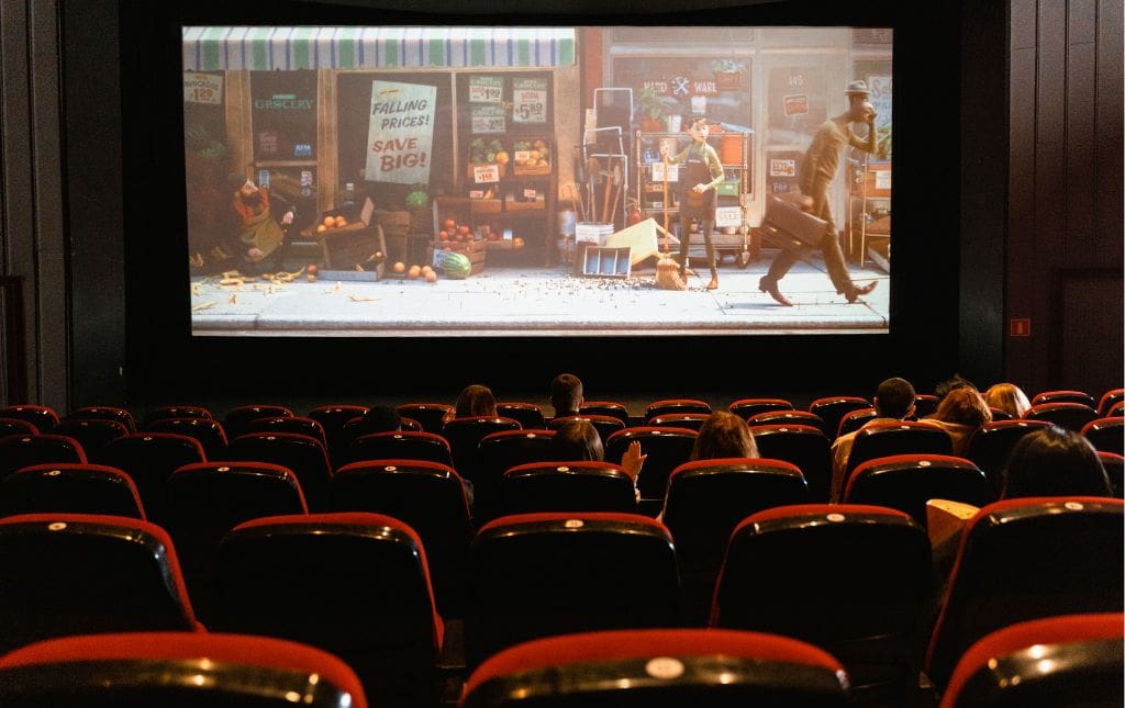 People sitting in a dark movie theatre