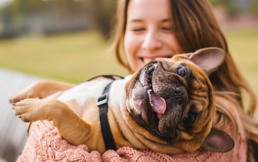 Teenage girl holding a cute dog