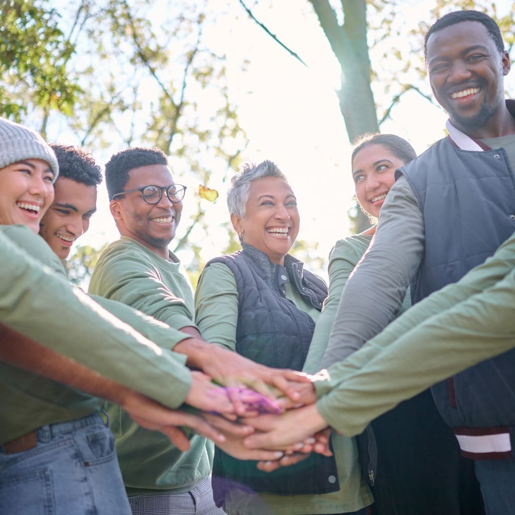 a group of volunteers with their hands together