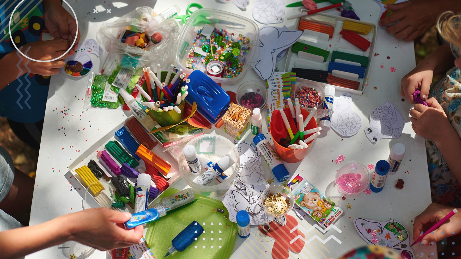 Children standing at table doing arts and crafts