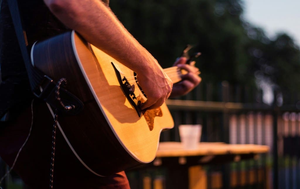 Man holding and playing guitar