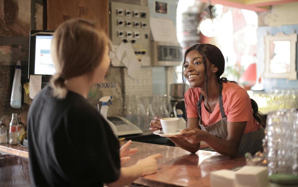 young lady ordering coffee at a counter