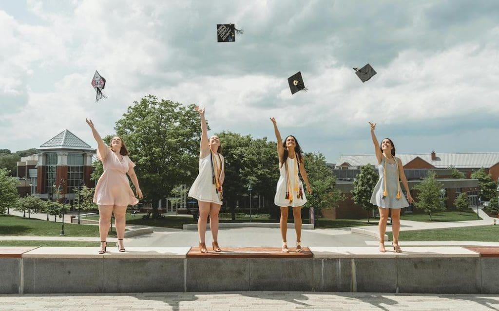 Students graduating and throwing up their caps