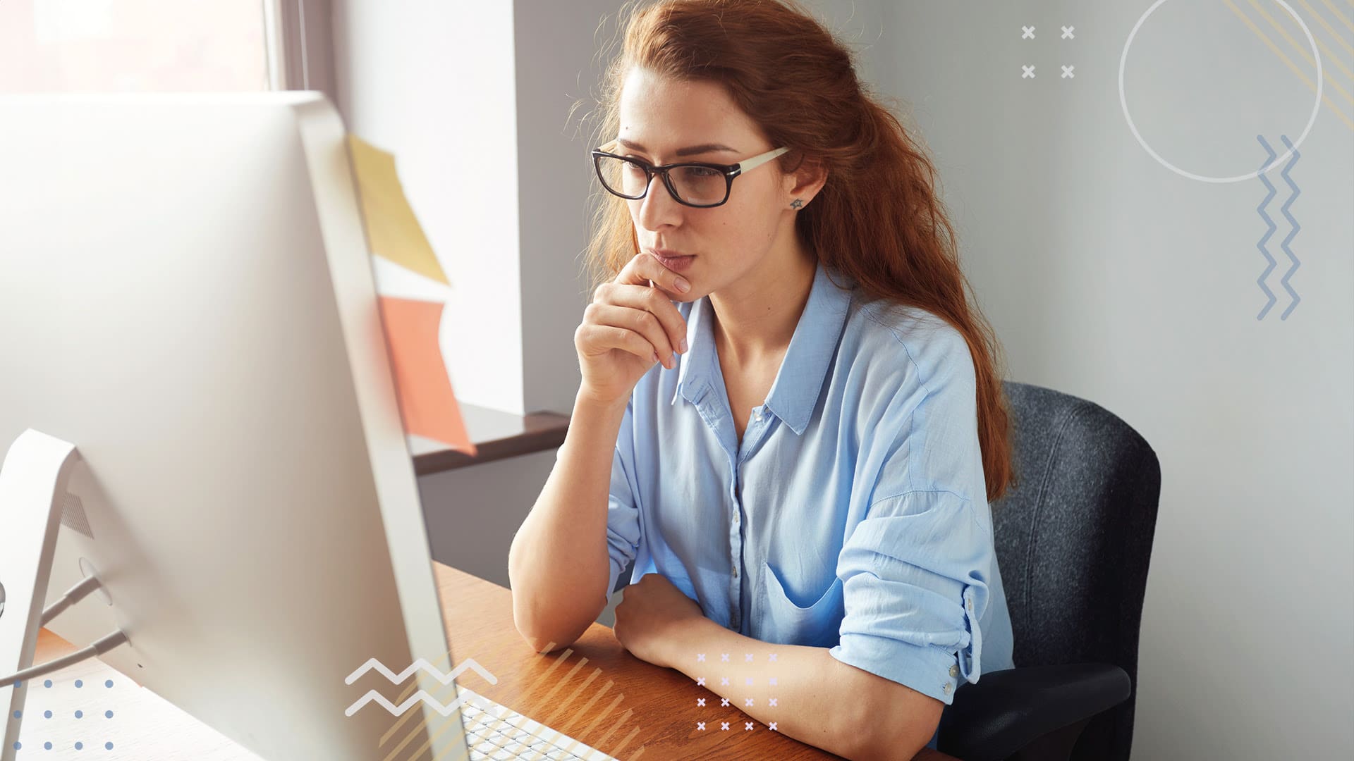 Woman sitting at desk on computer planning fundraiser