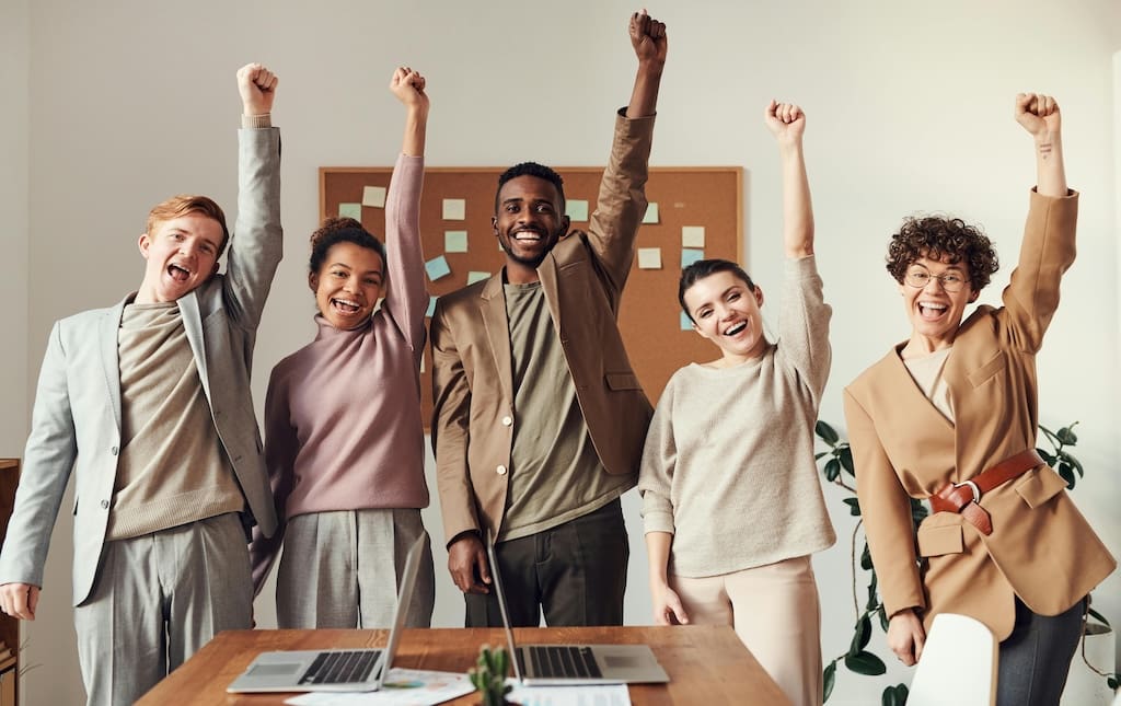 people working and holding their fist in the air