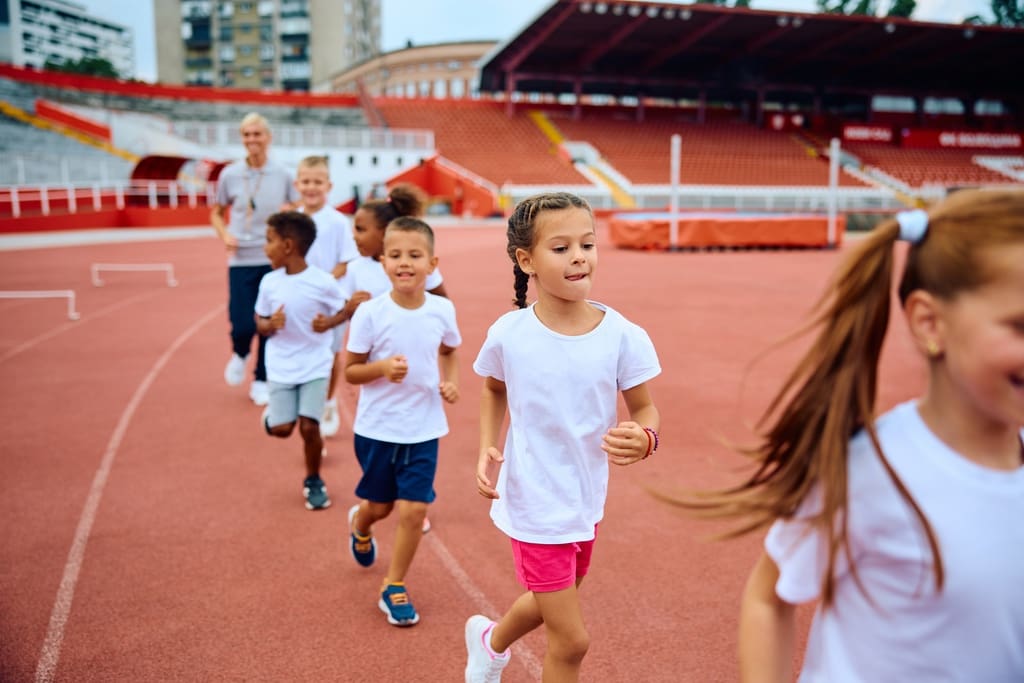 Group of elementary students participating in school fun run fundraising event