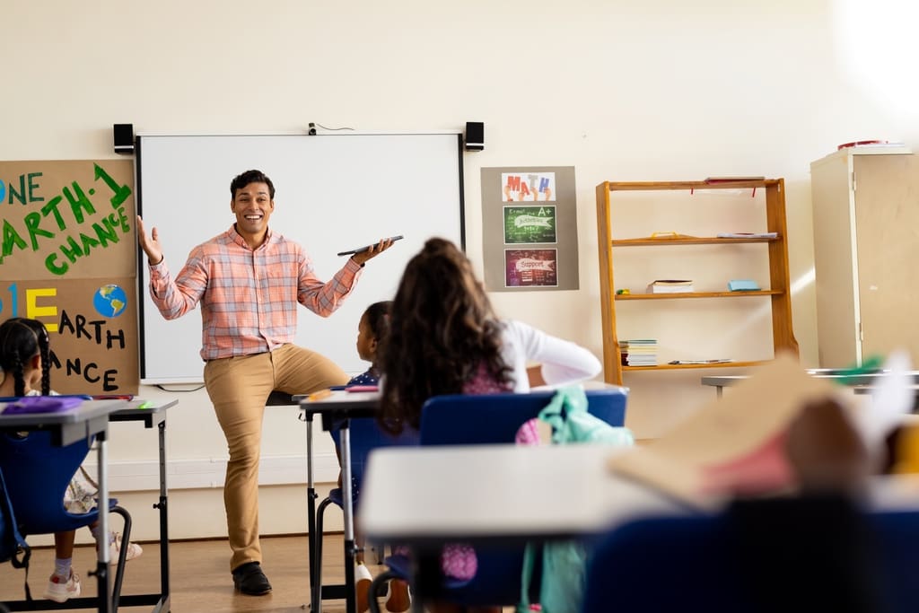 Teacher answering questions in classroom before penny war fundraiser starts