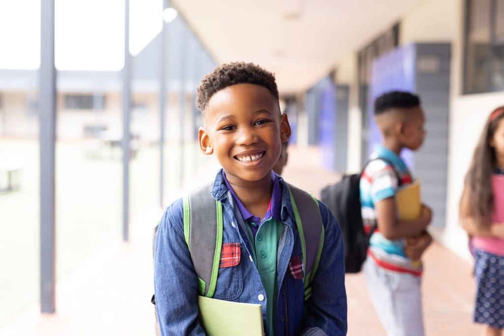 Smiling student being made hall monitor as individual reward for fundraiser participation