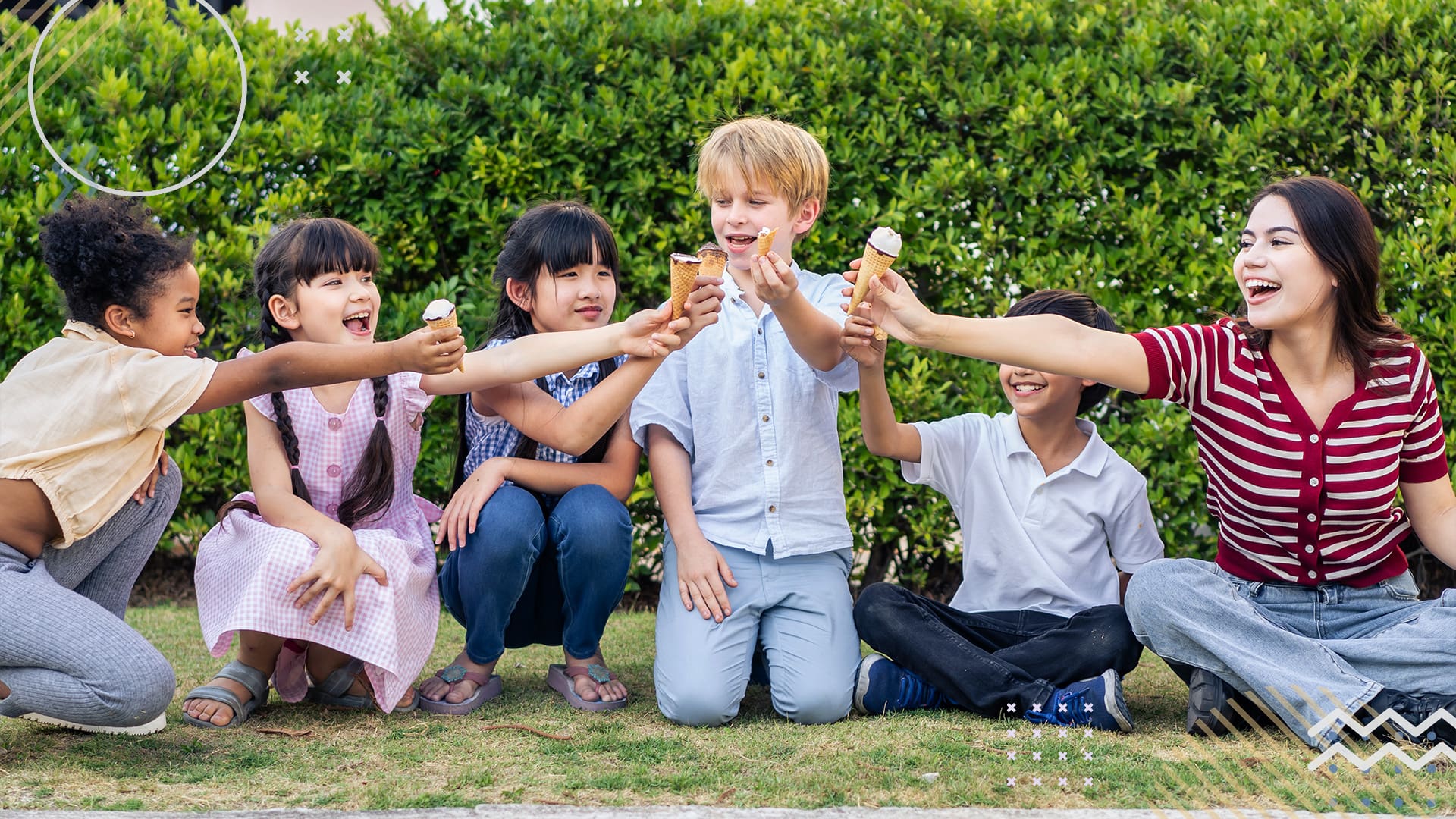 Group of children sitting on grass eating ice cream